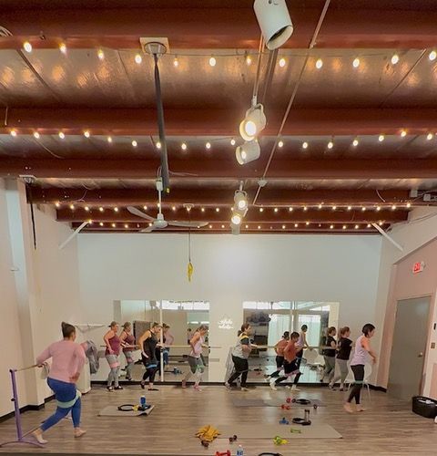 A group of people are dancing in a dance studio.