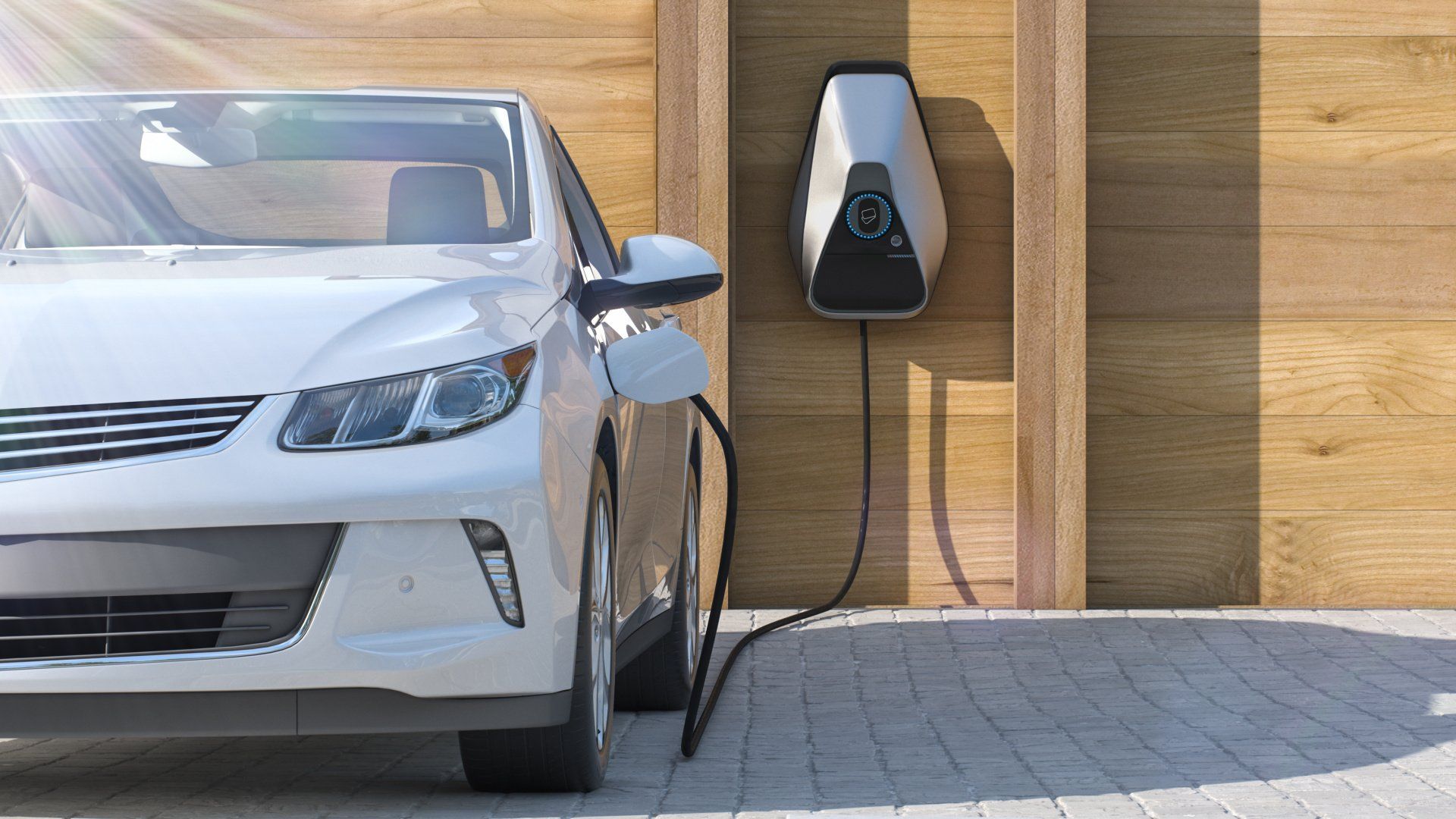 A white electric car is being charged at a charging station.