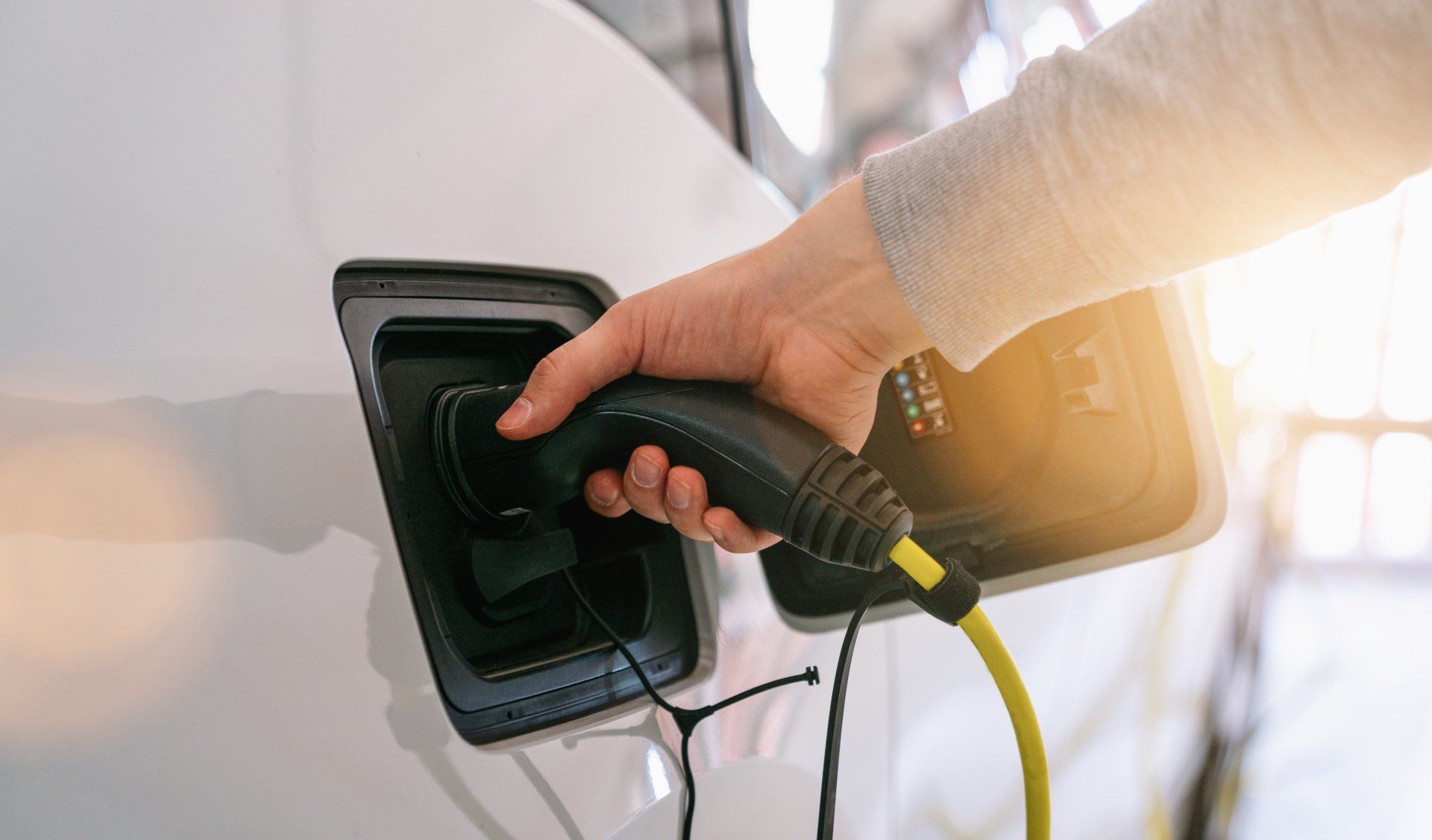 A person is charging an electric car with a charger.