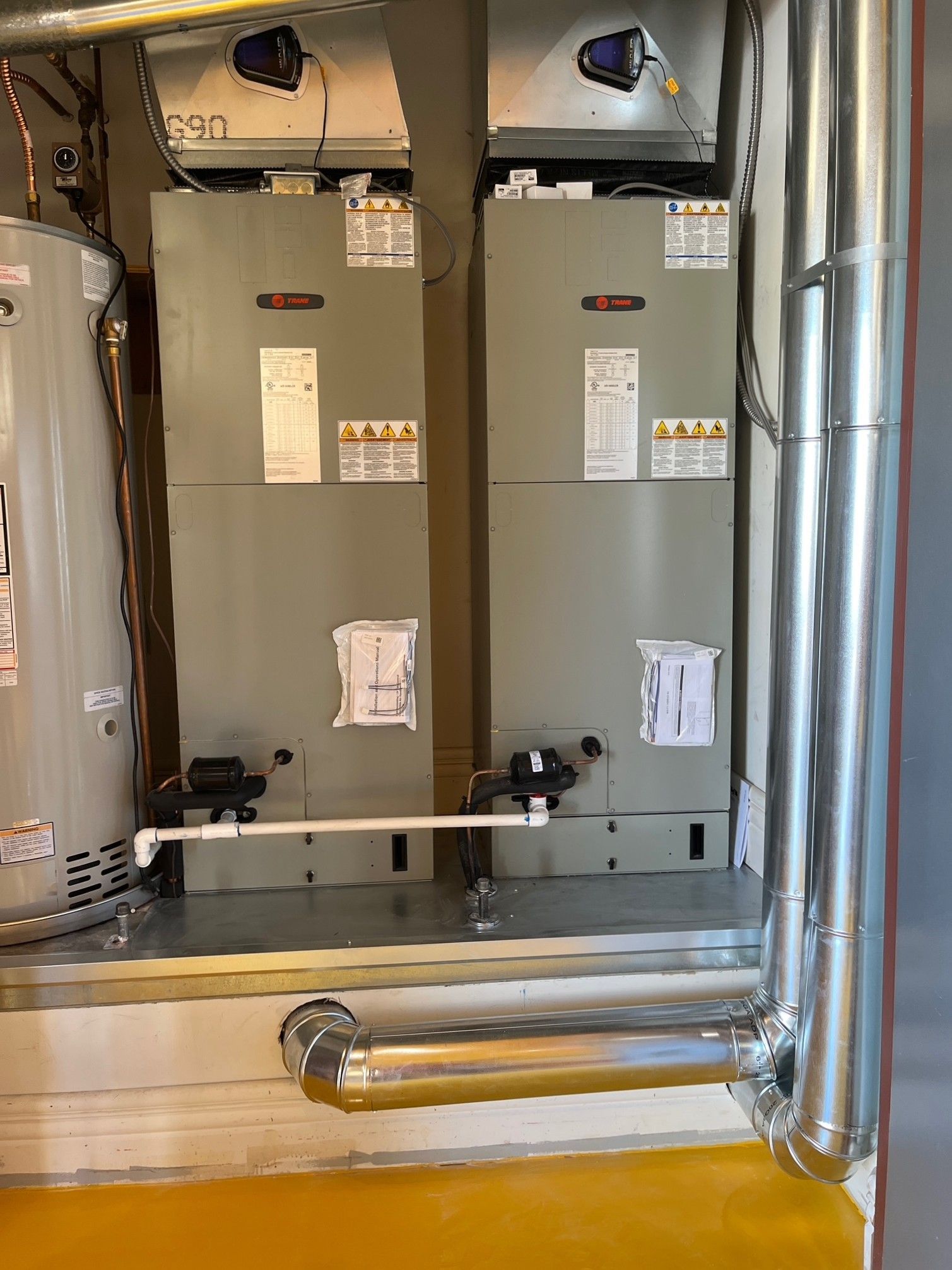 A room with two heaters and a water heater in it.