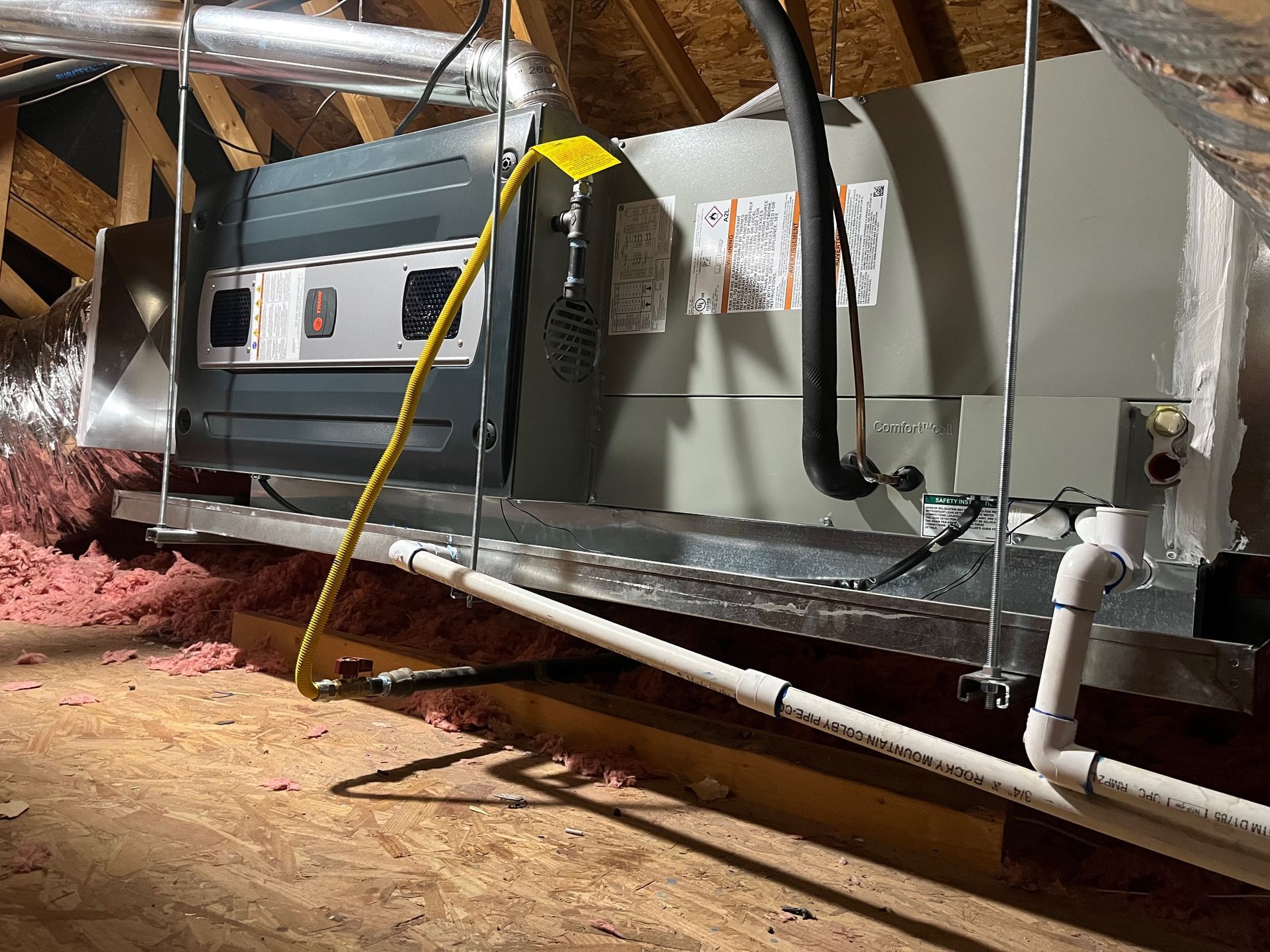 An air conditioner is installed in the attic of a house.