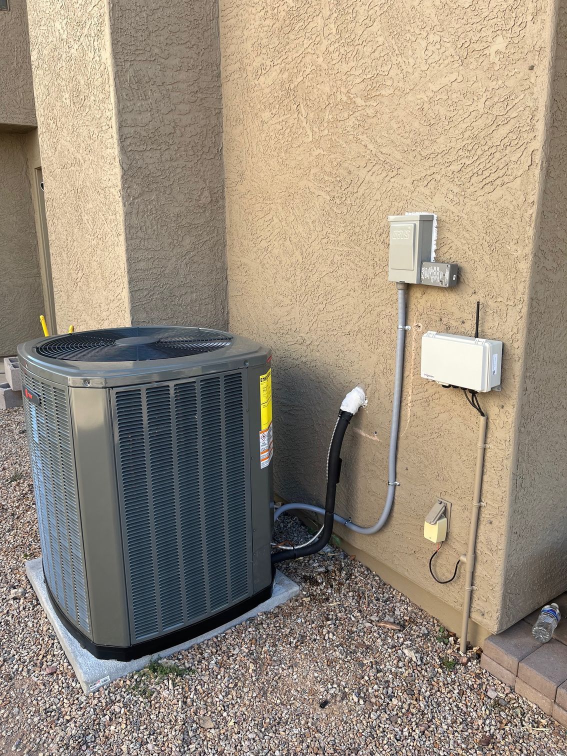 An air conditioner is sitting on the side of a building.