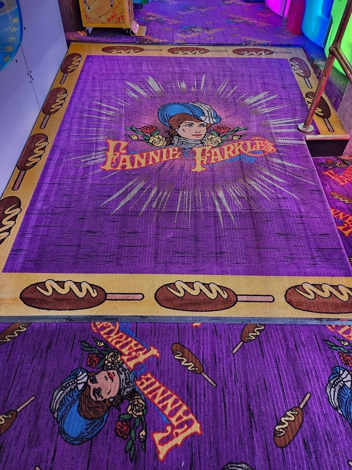 A purple rug with a picture of a girl on it.