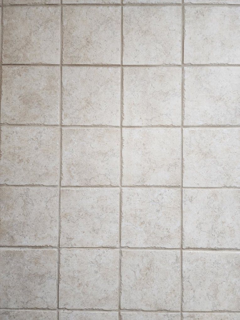 A close up of a tiled floor with a lot of squares.