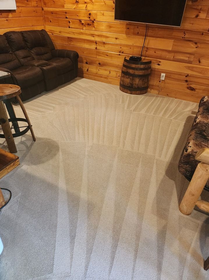 A living room with a couch , chair , and television.