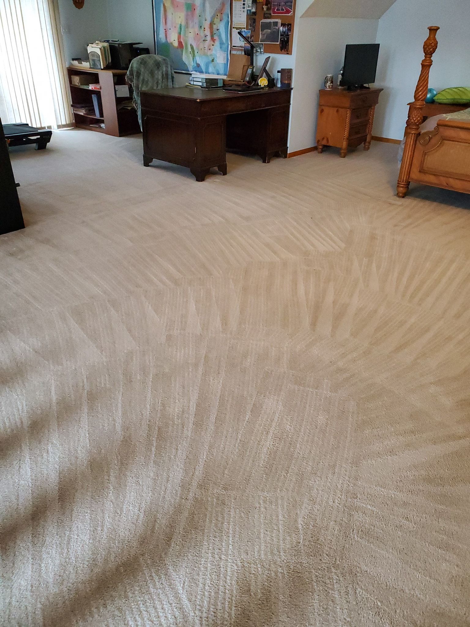 A room with a desk and a bed in it.