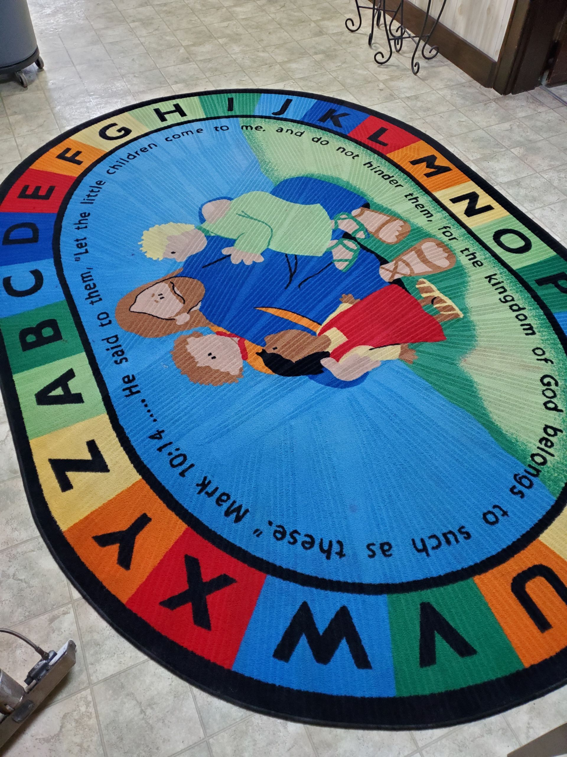 A vacuum cleaner is sitting on a carpeted floor in a hallway.