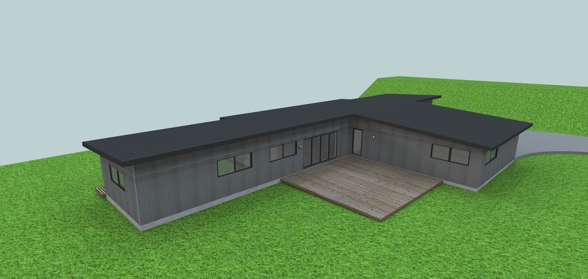 A 3d model of a house with a black roof is sitting on top of a lush green field.