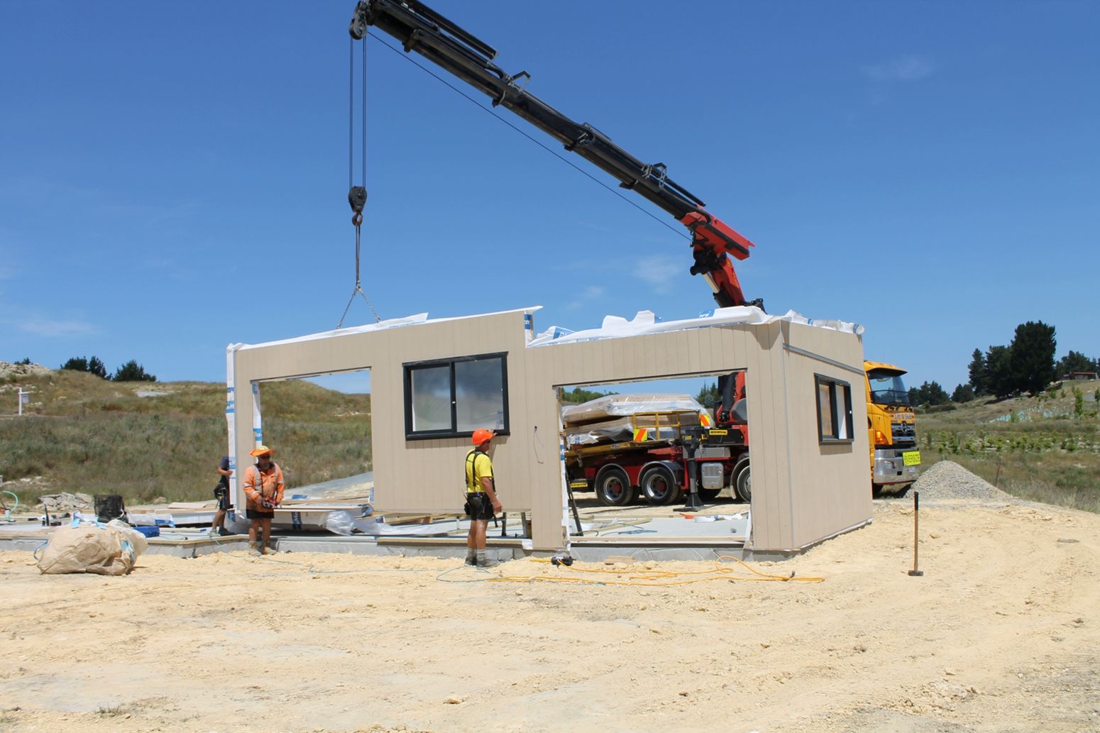 A crane is lifting a building on a construction site.