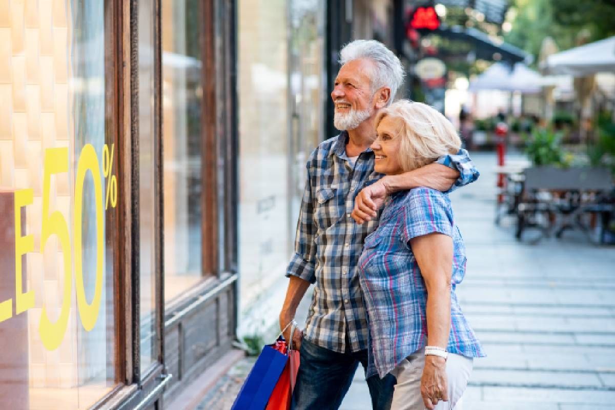 An active senior couple window shopping at a store near Lexington, Kentucky (KY)