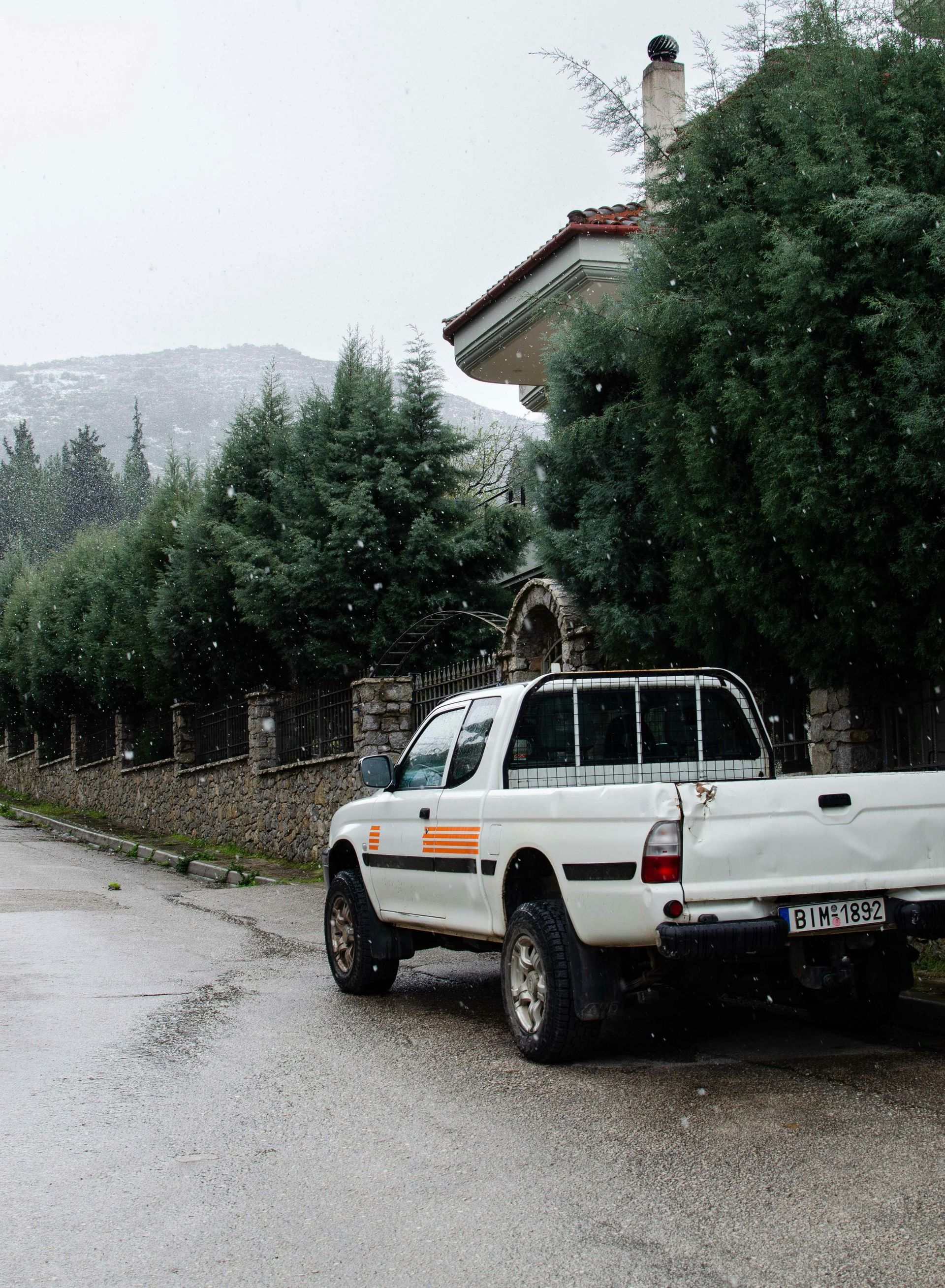 A white truck is parked on the side of the road