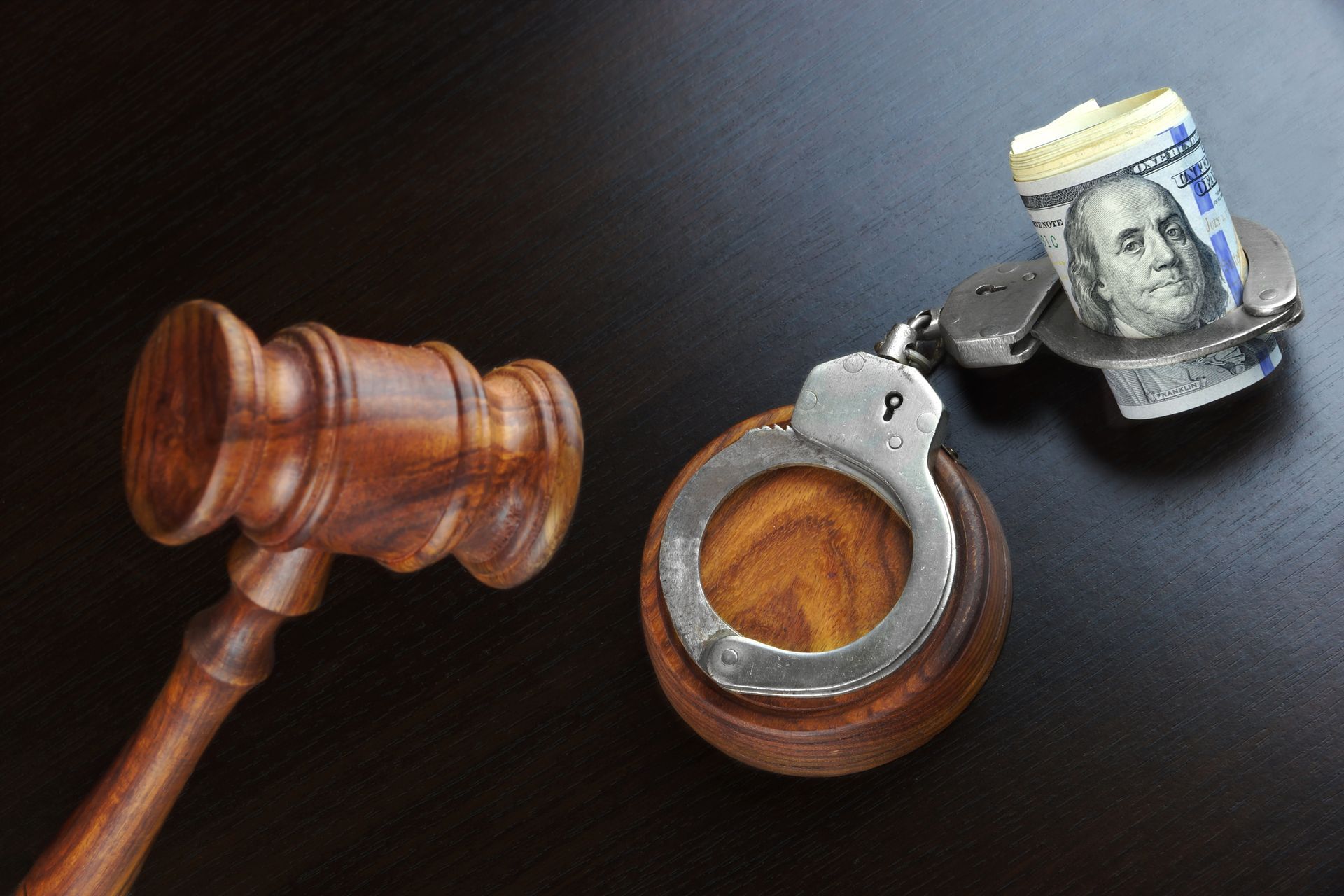 Judges gavel and money on table, highlighting bail bonds services for quick legal assistance.