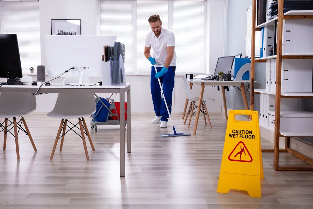 Janitor With Mop Cleaning Office Floor