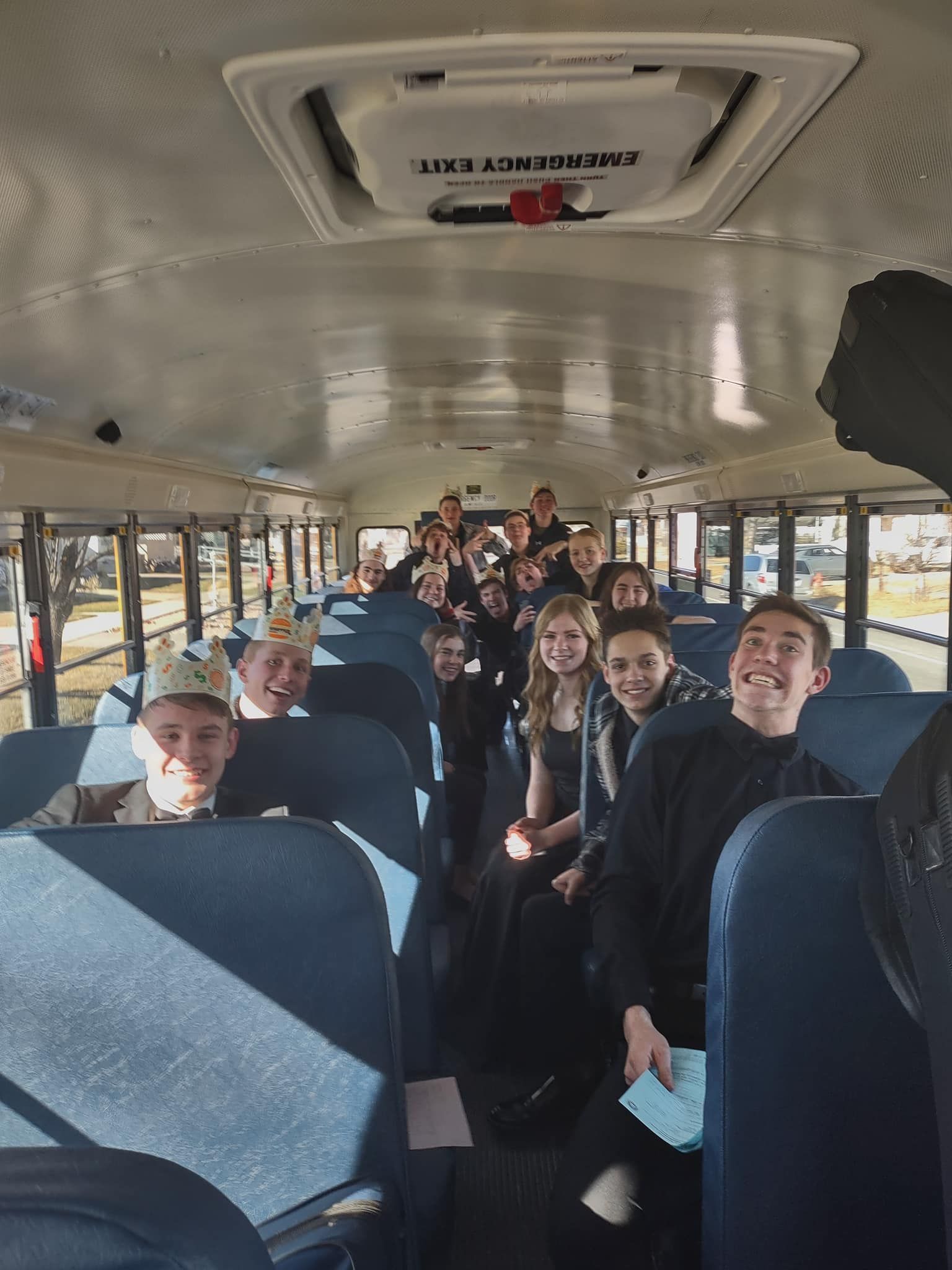a group of people are sitting on a school bus .Jazz band students .