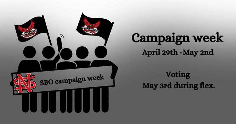 A group of people holding flags and a sign that says SBI campaign week April 29th- May 2nd. Voting May 3rd