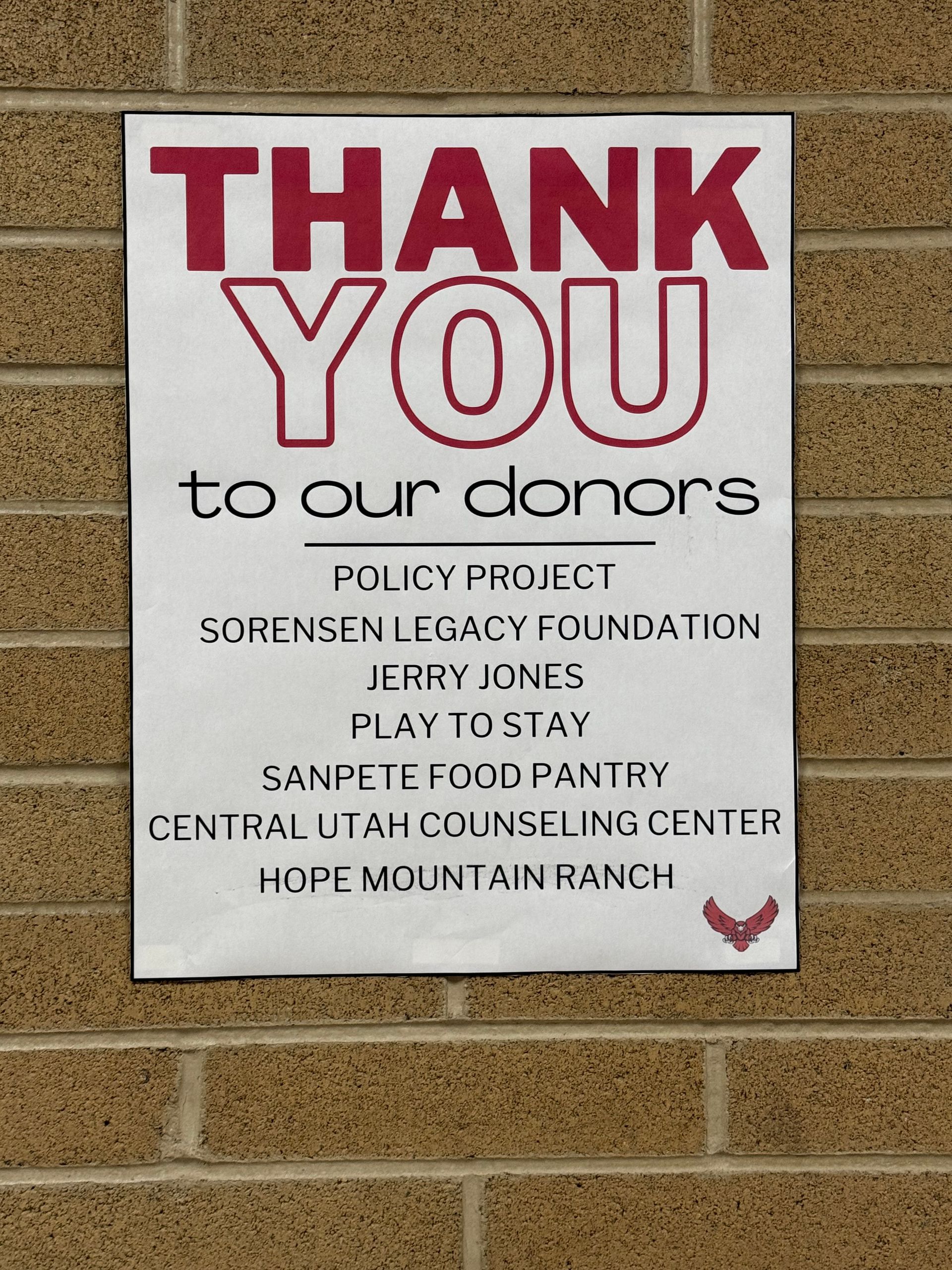 A sign on a brick wall that says thank you to our donors