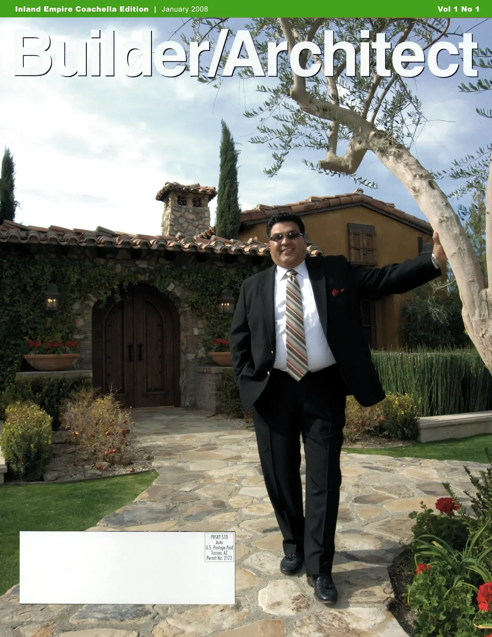 A man in a suit and tie is on the cover of builder architect