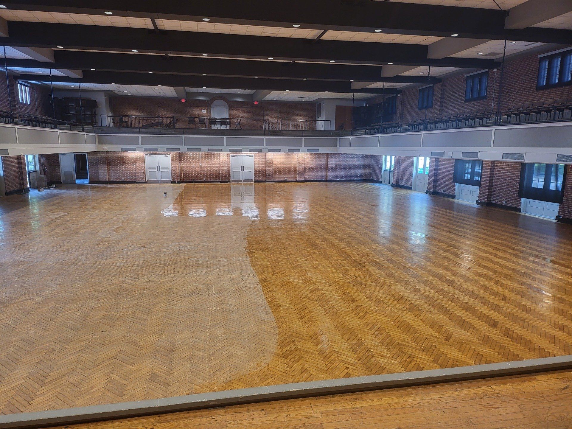 A large empty ballroom with a wooden floor
