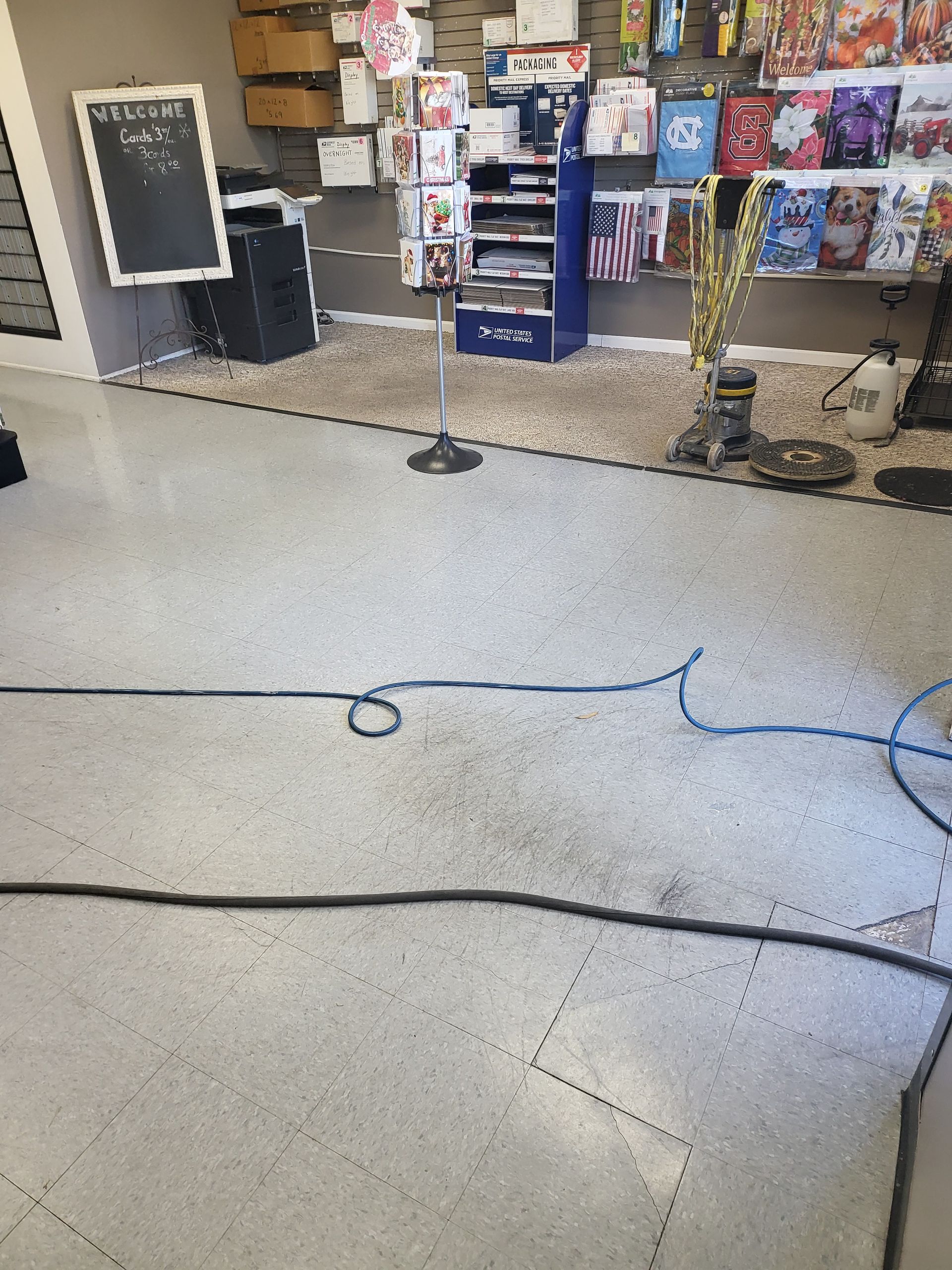 A vacuum cleaner is being used to clean the floor of a store.