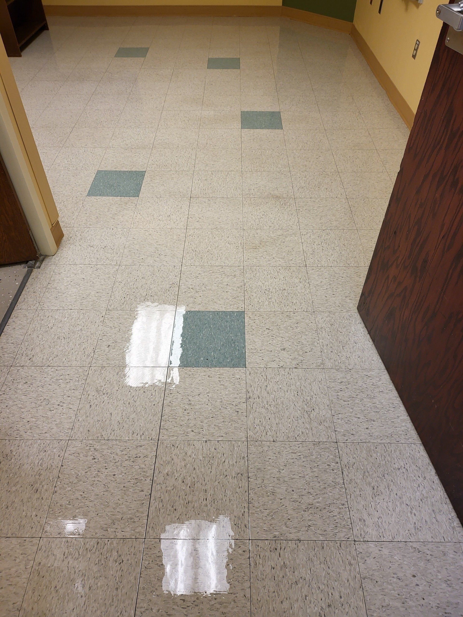 A tiled floor with green squares on it