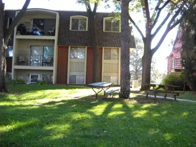 a house with a picnic table in front of it