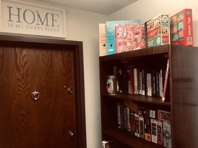 a sign above a door that says home is my happy place