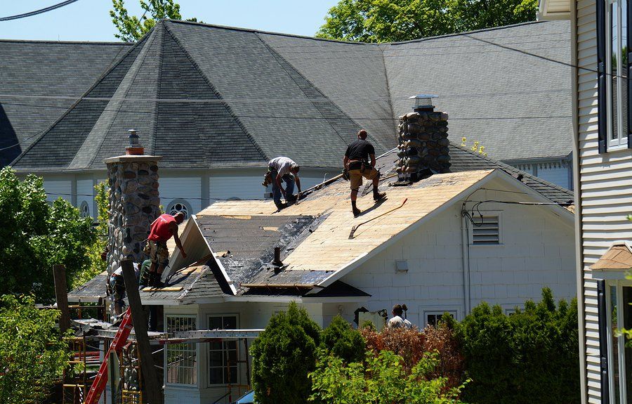 worker repairing the house roof