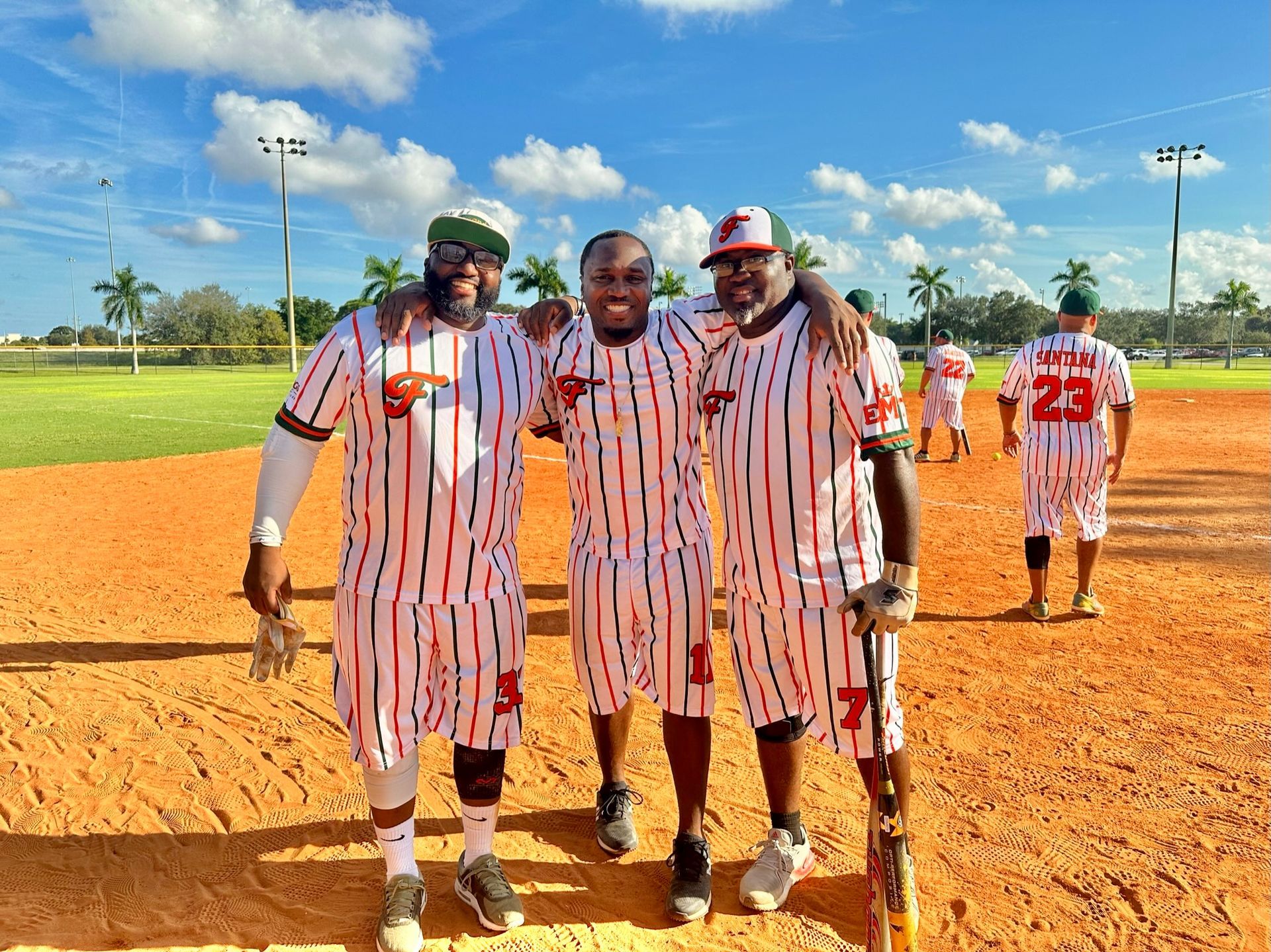 Players on the field in red pinstripes