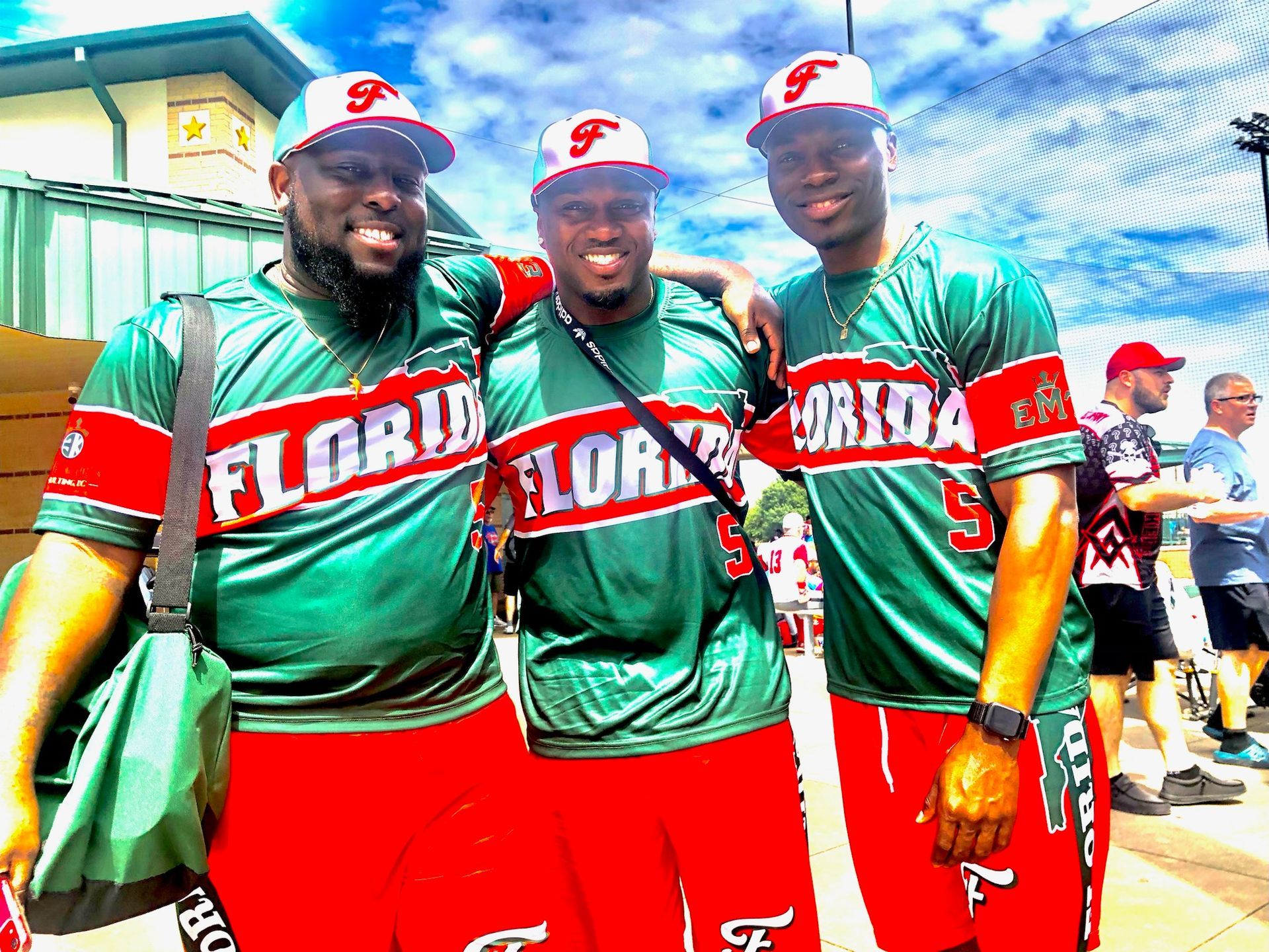 Team Florida players celebrating in green and red uniforms