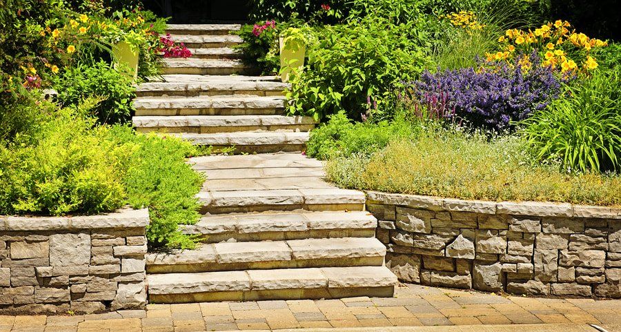 stone stairs surrounded by retaining walls with beautiful garden and landscaping planted within