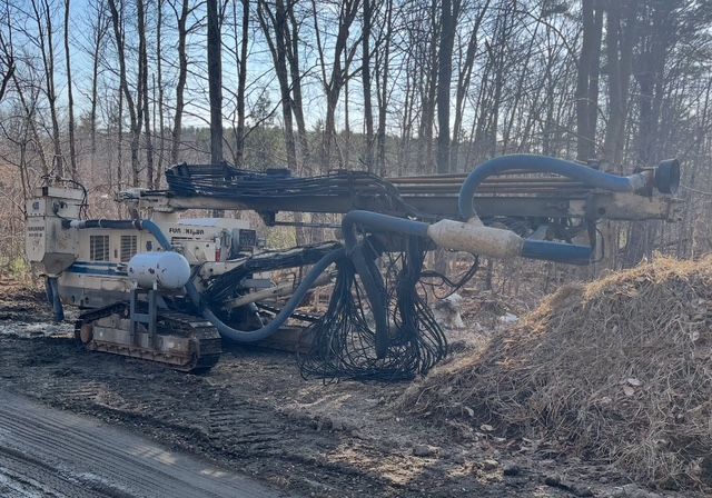 A pile of rocks in a rocky area with mountains in the background.