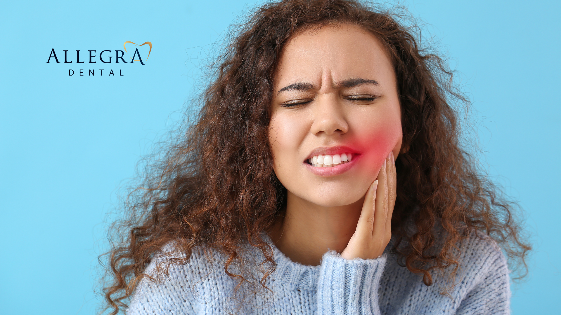 A woman is holding her face in pain because of a toothache.