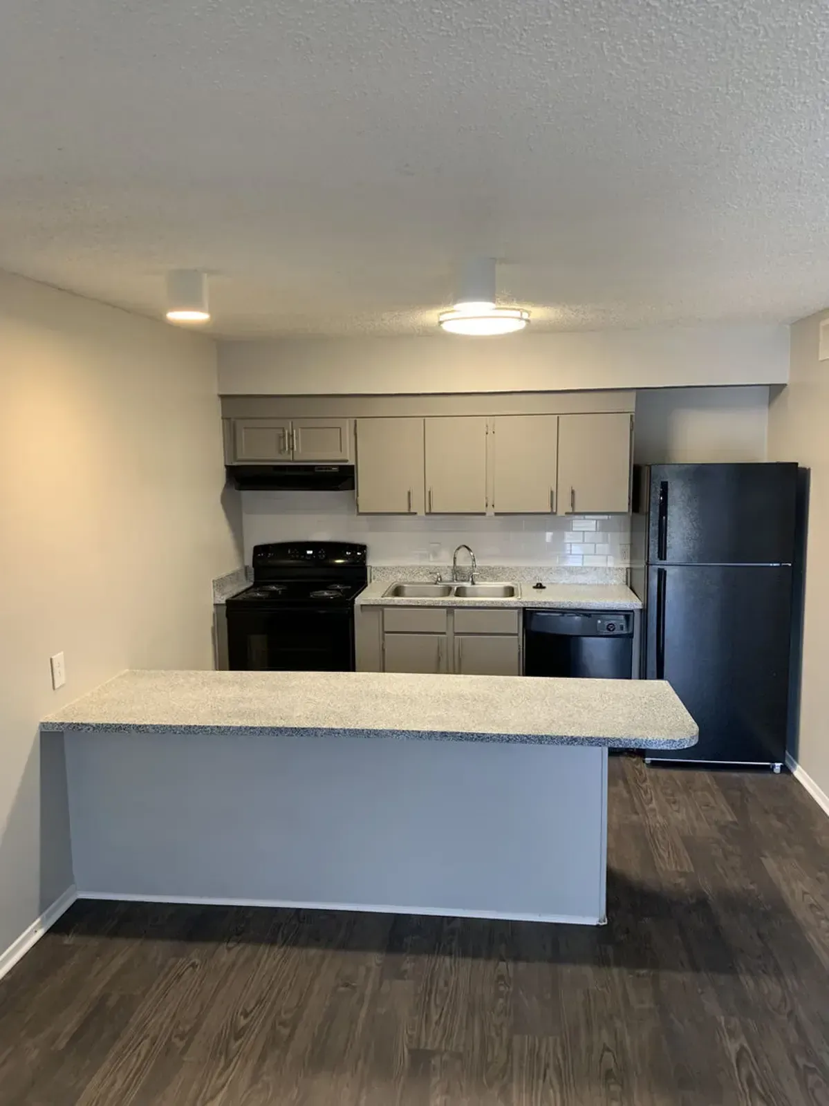 A kitchen with a refrigerator , stove , sink , and dishwasher.
