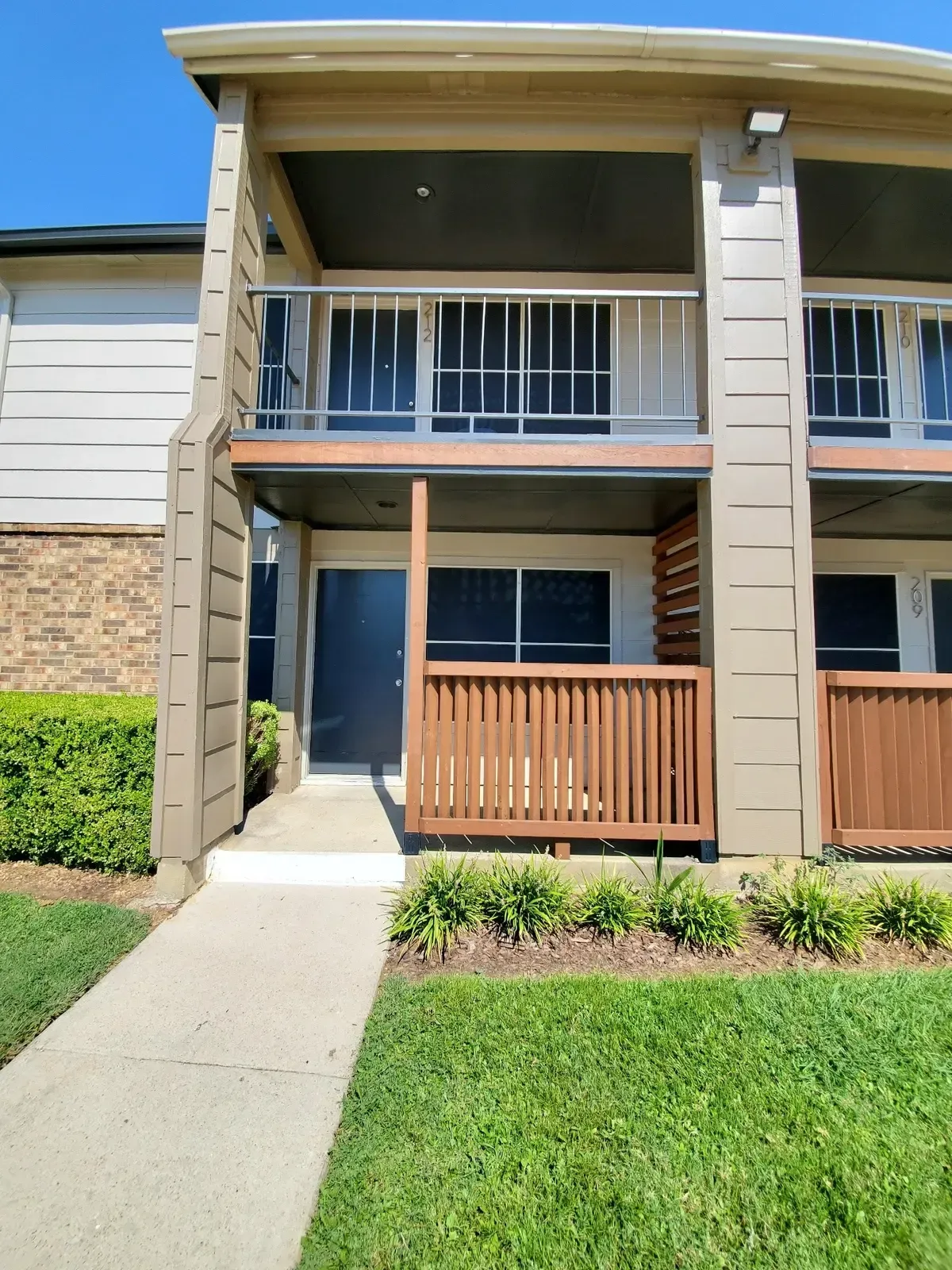 A house with a balcony and a walkway leading to it