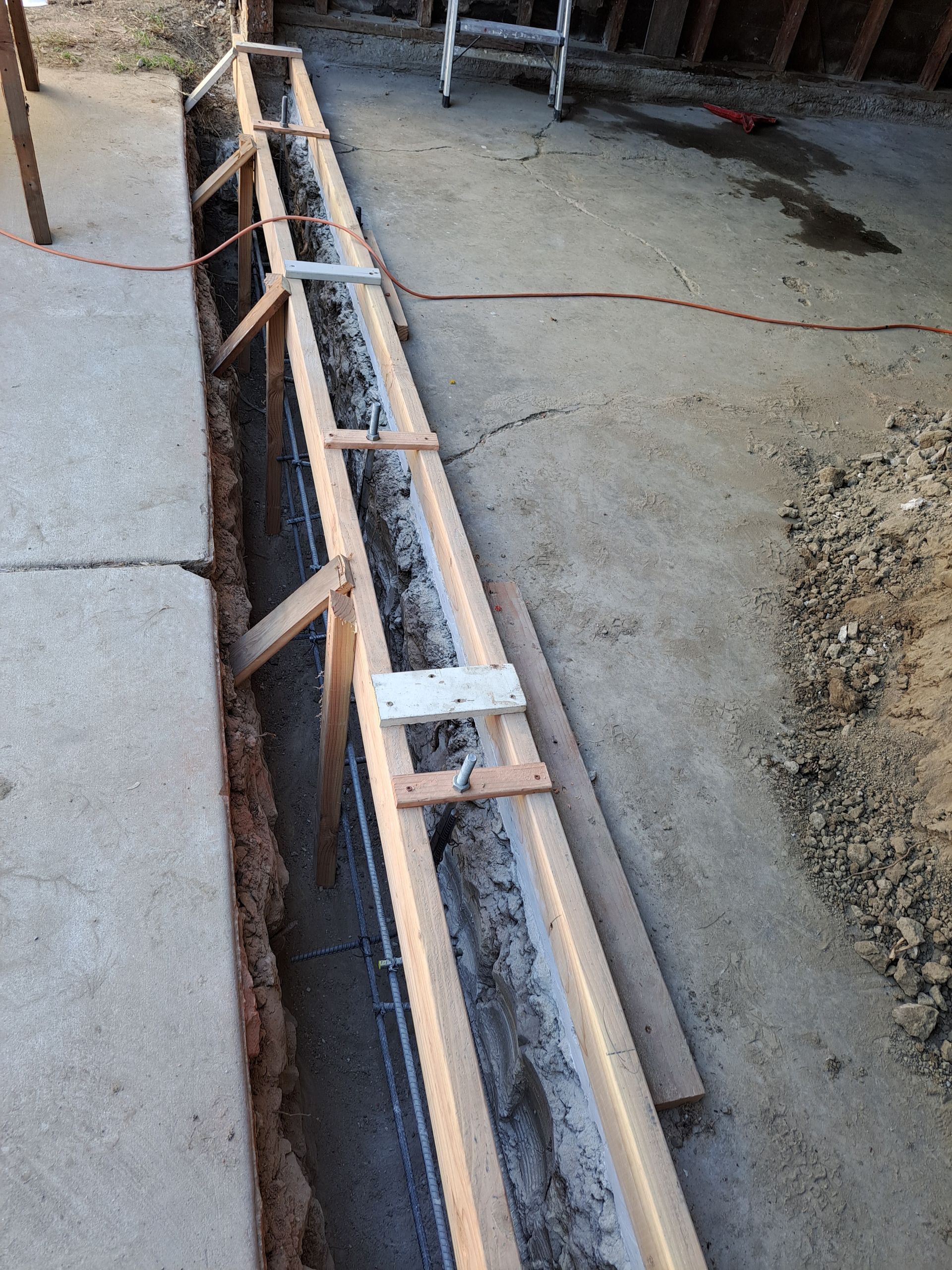 A concrete wall is being built with a wooden frame.