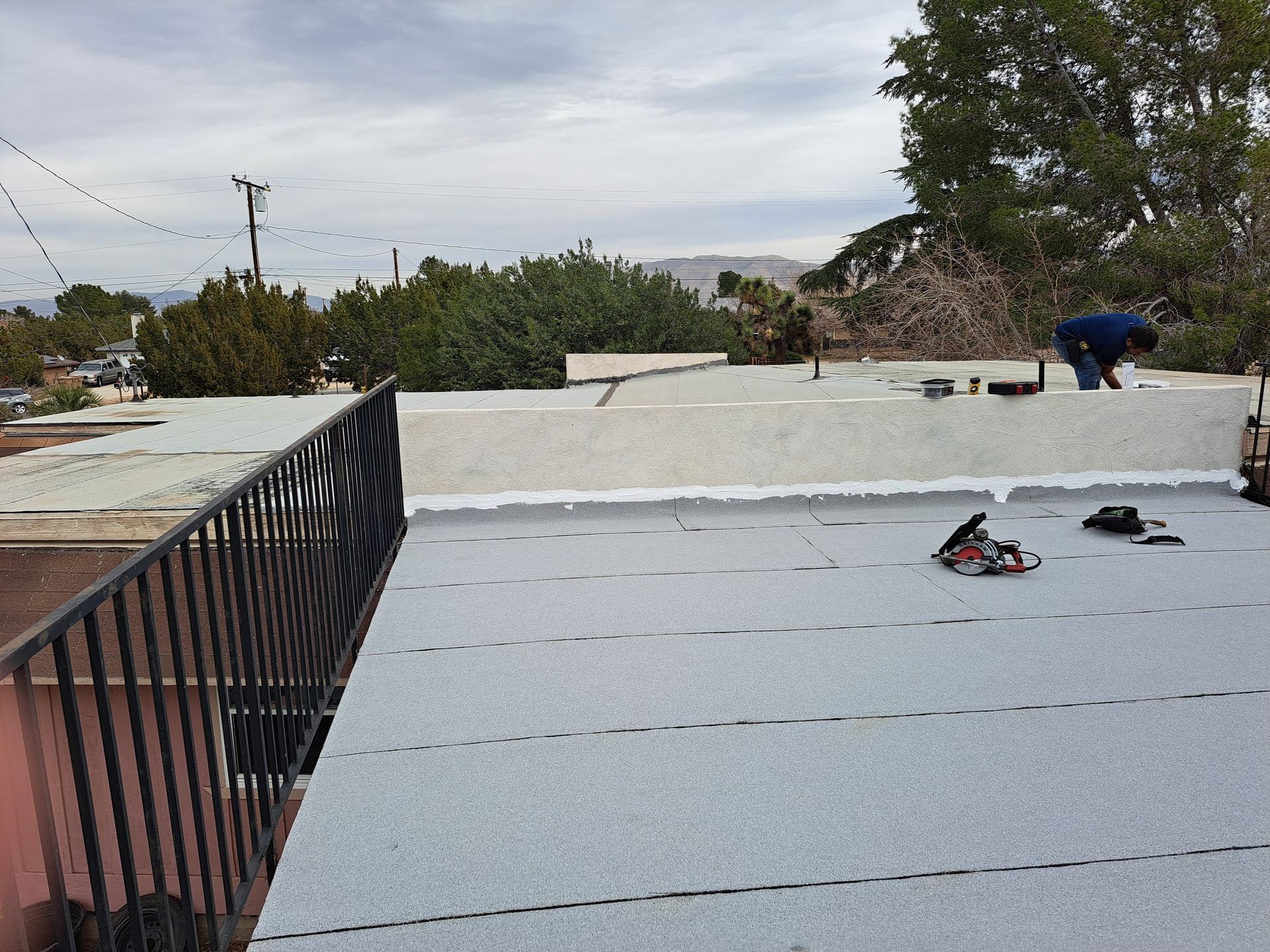 A man is working on the roof of a building.