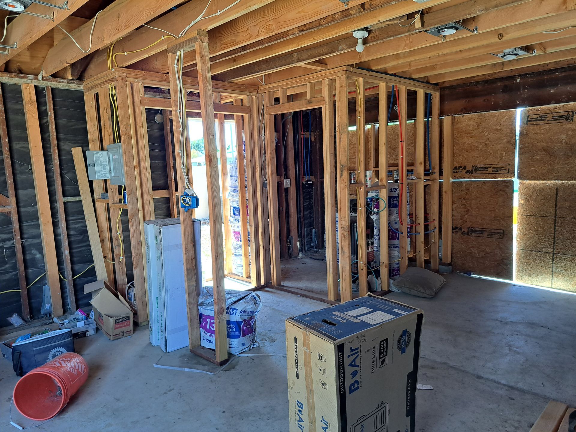 A room in a house under construction with a box on the floor.