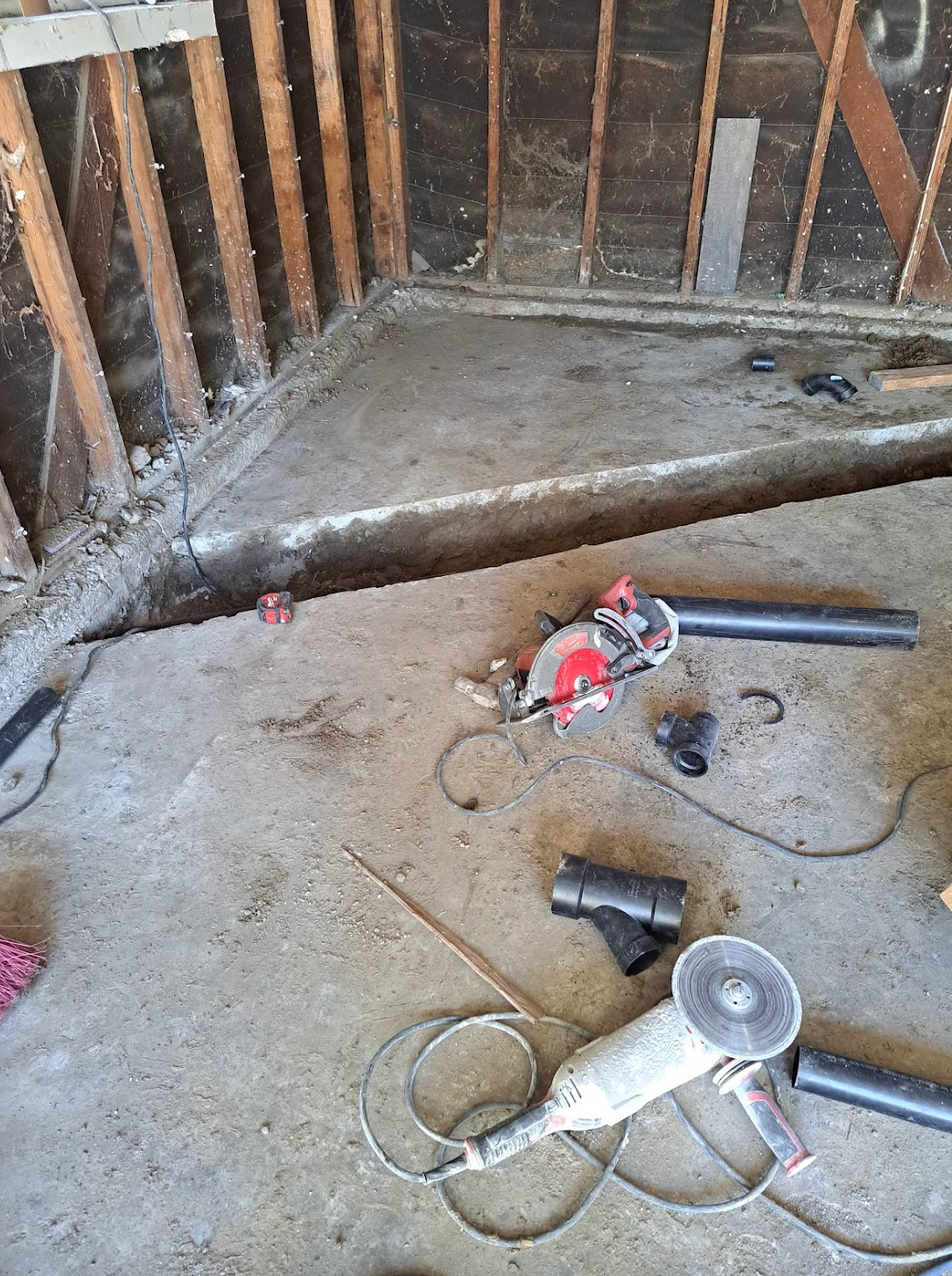 A bunch of tools are laying on the floor in a room.