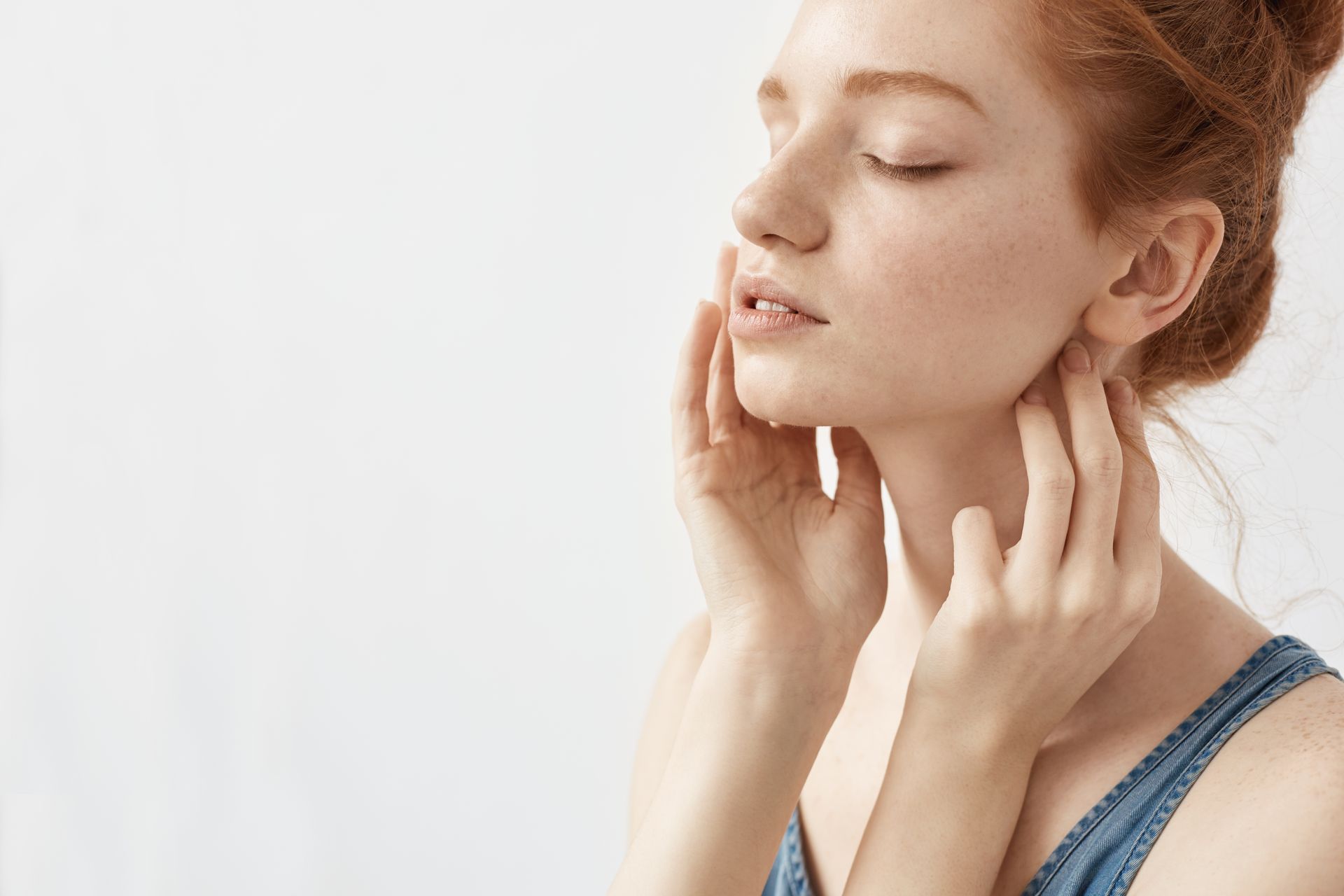 woman with beauty skin with hands on her cheek