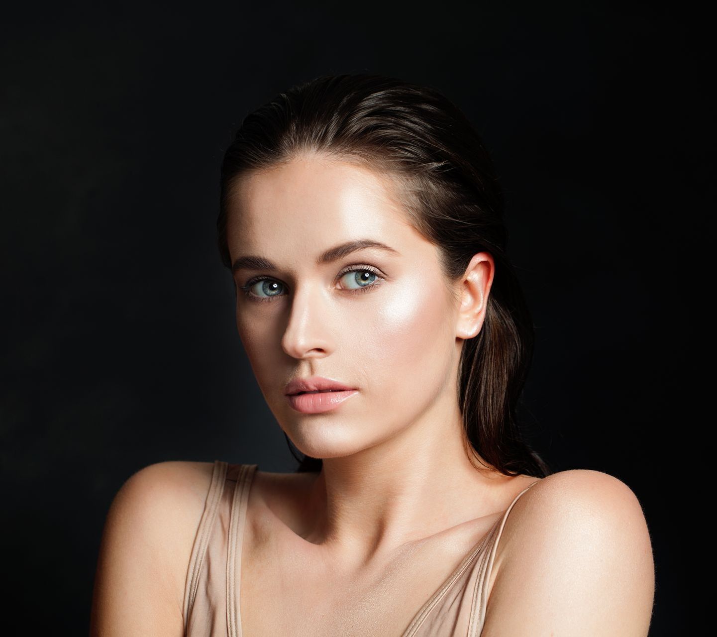 A close up of a woman 's face on a black background.