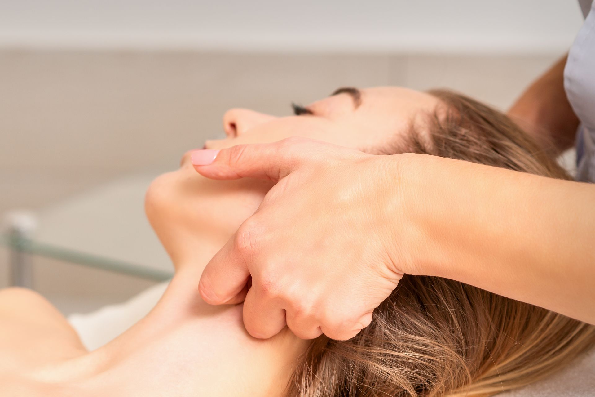 A woman is getting a neck massage from a doctor.