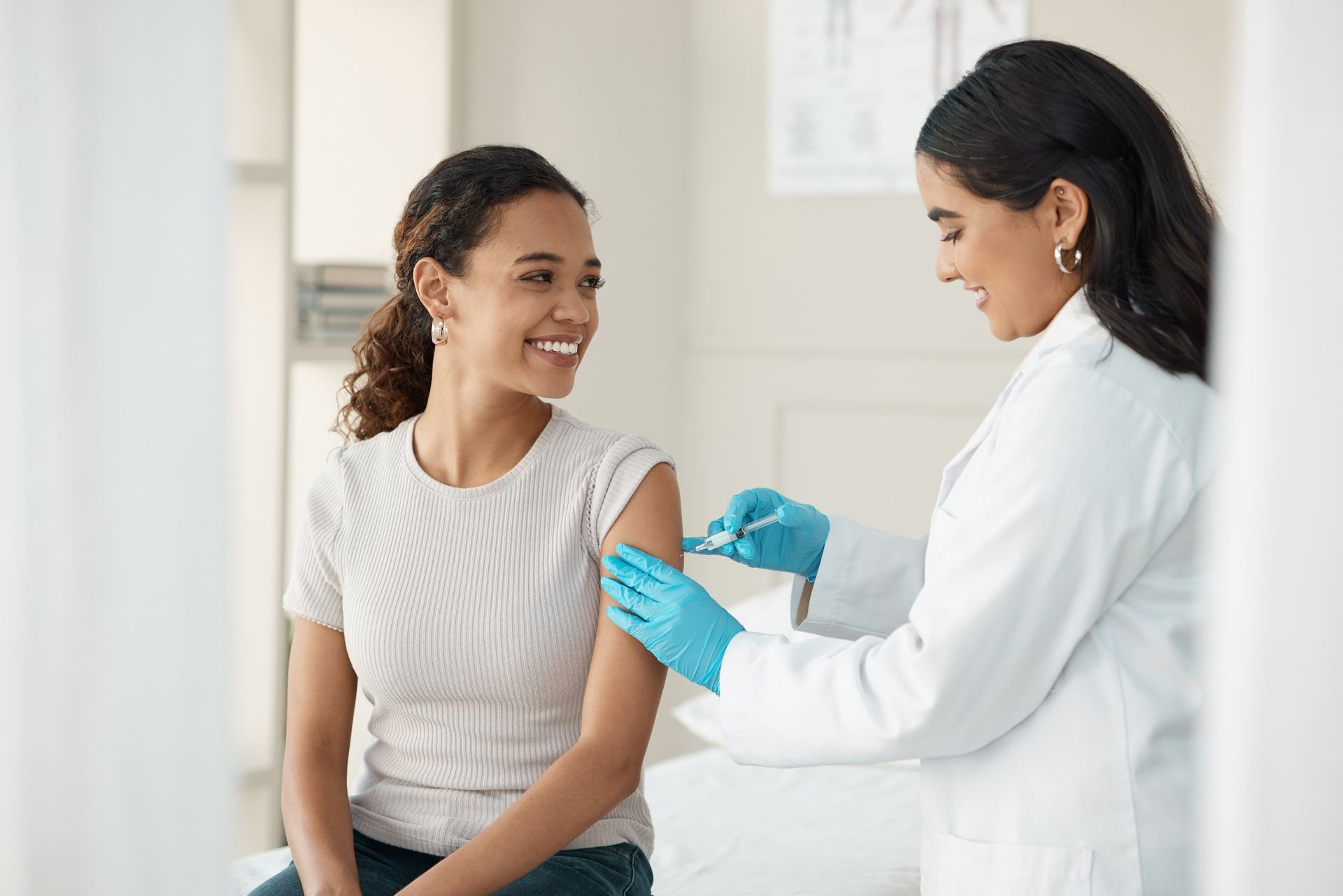 A doctor is giving a girl an injection in her arm.