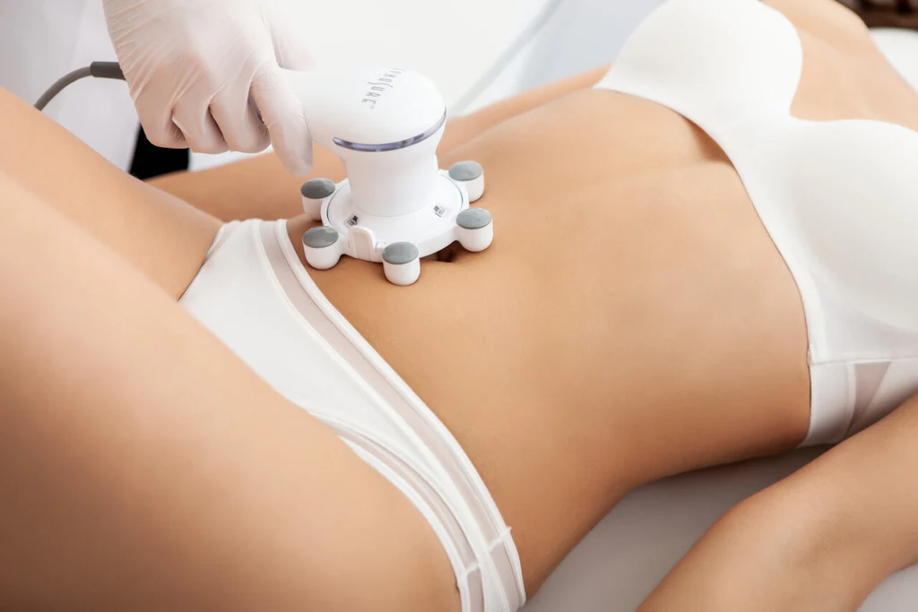 A woman in white underwear is getting a massage on her stomach.