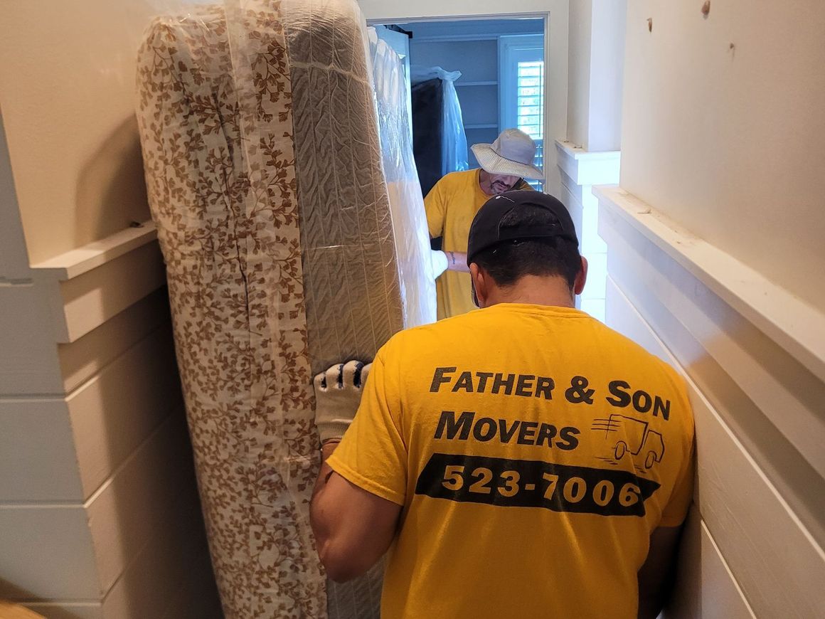 A man wearing a yellow shirt that says father & son movers