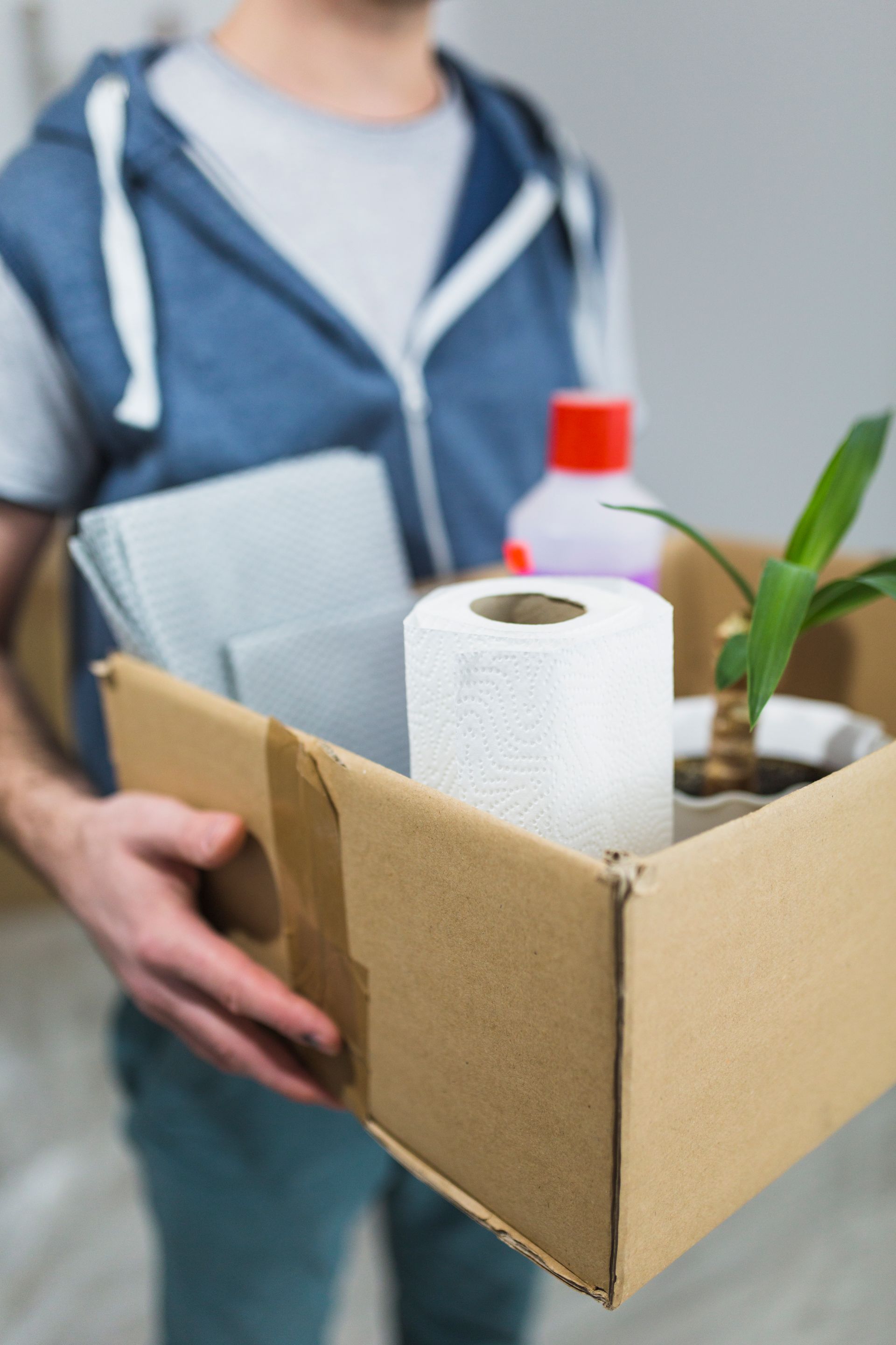 Man carrying box with office items.