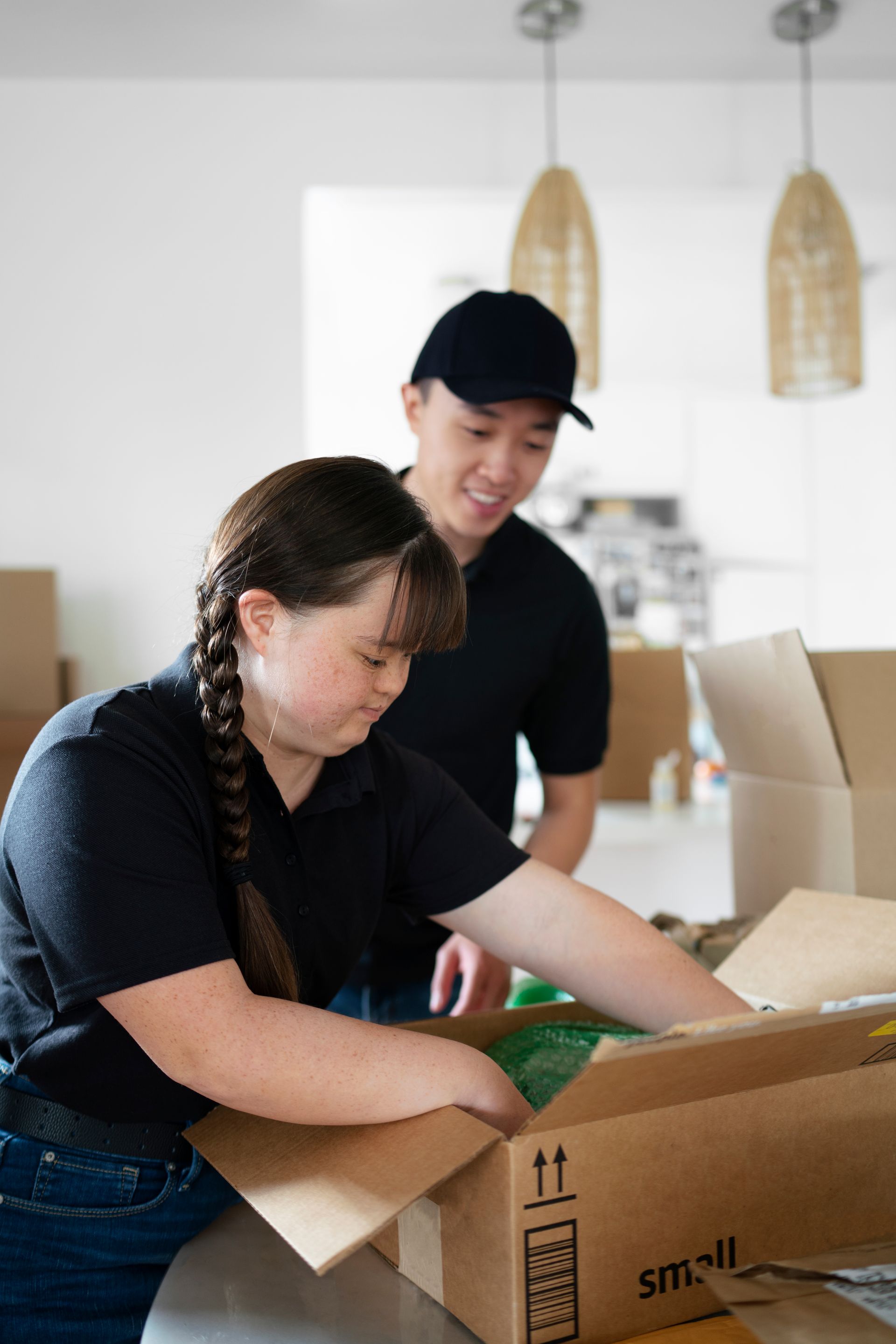 Two movers are loading boxes.