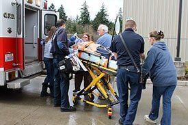 Patient on stretcher getting inside ambulance - Medical personnel in Upland, CA