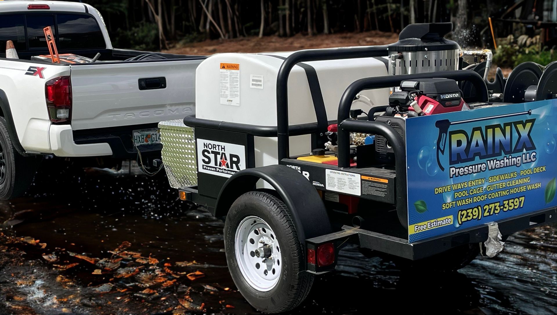 A white pickup truck towing a pressure washing trailer with a water tank, engine, and 