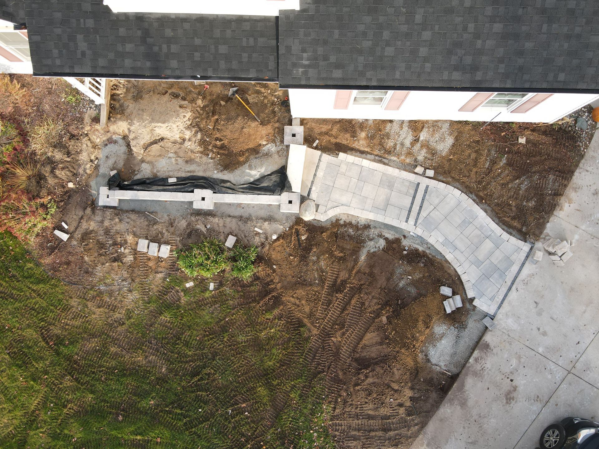 An aerial view of a walkway being built in front of a house.