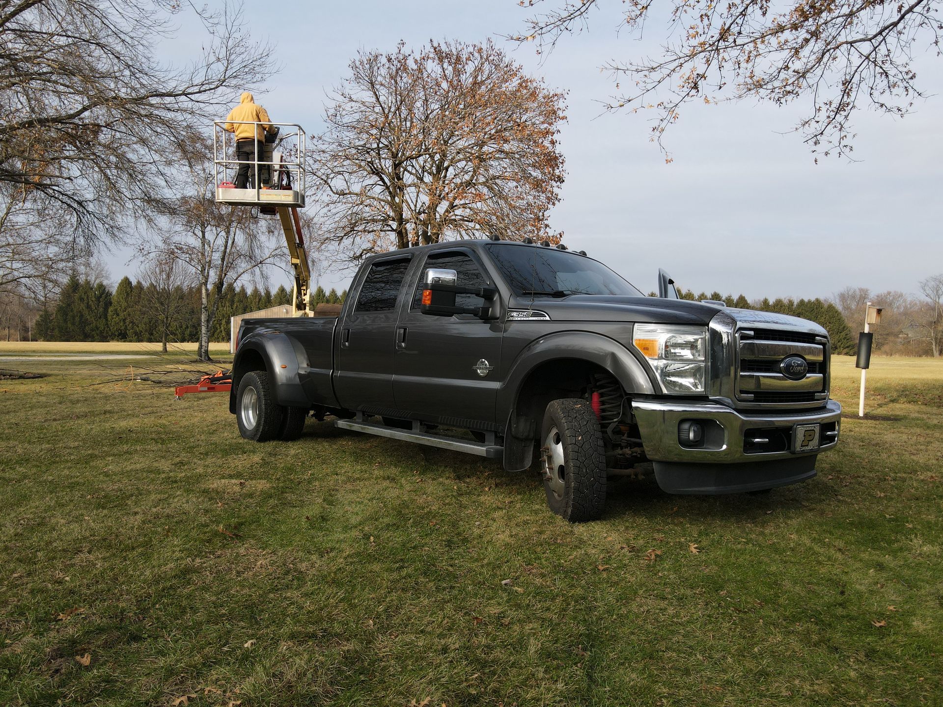 A truck is parked in a grassy field with a fire hydrant in the background.
